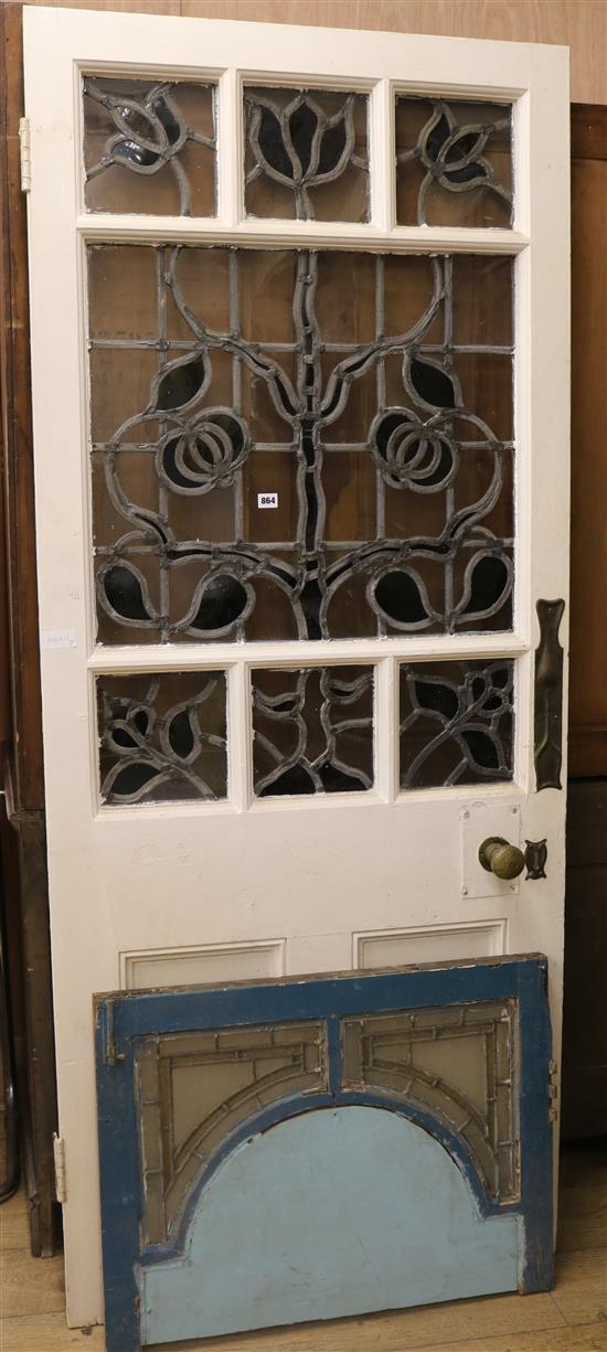 An Art Nouveau  Tree of Life stained glass panelled door and another panel. w.86cm